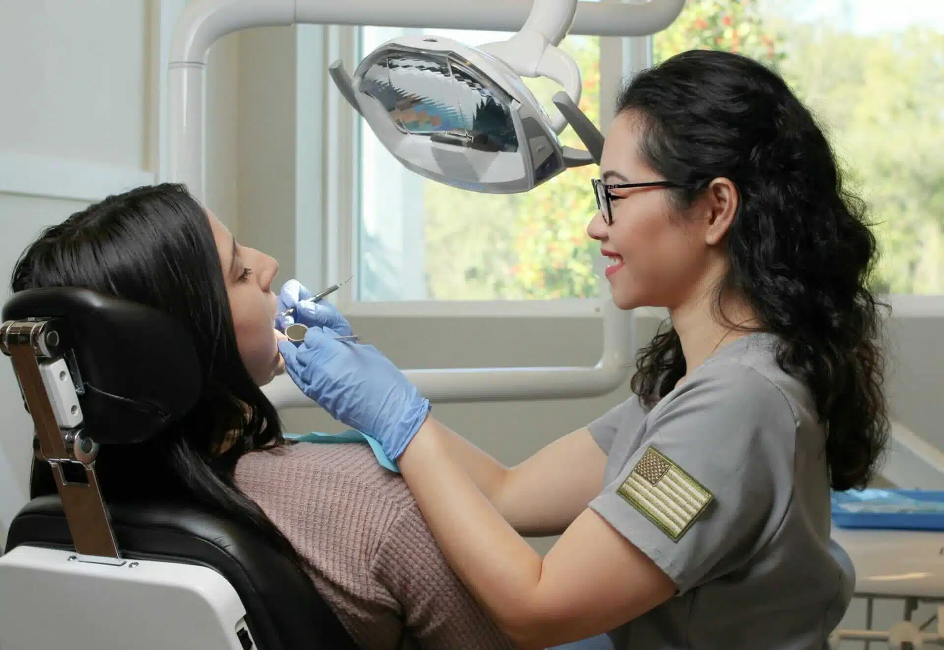 Dental hygienist providing a dental check-up to a patient at Southern Style Dental office. Professional and friendly care.