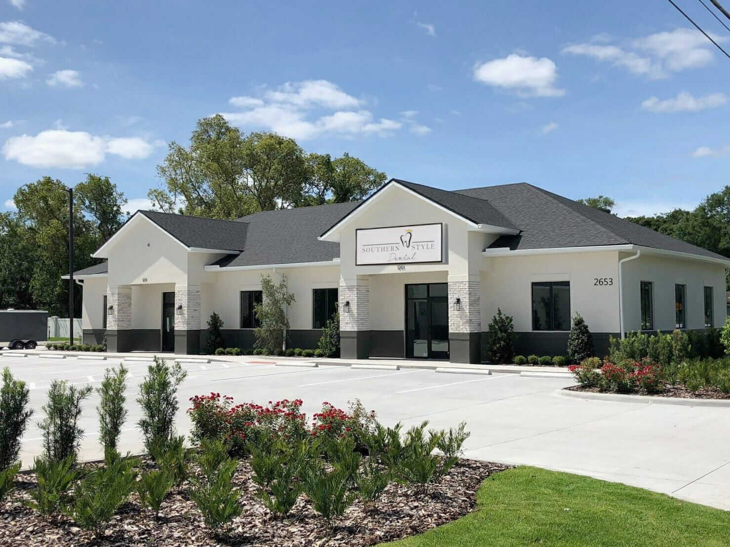 Southern Style Dental Office - Front view of the Southern Style Dental building with landscaping and parking area on a sunny day.
