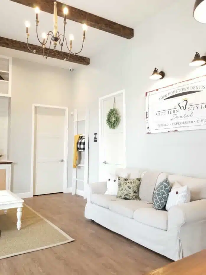 Welcoming and cozy waiting area at Southern Style Dental with a sofa, cushions, and chic decor. Trusted dental care in a homely setting.