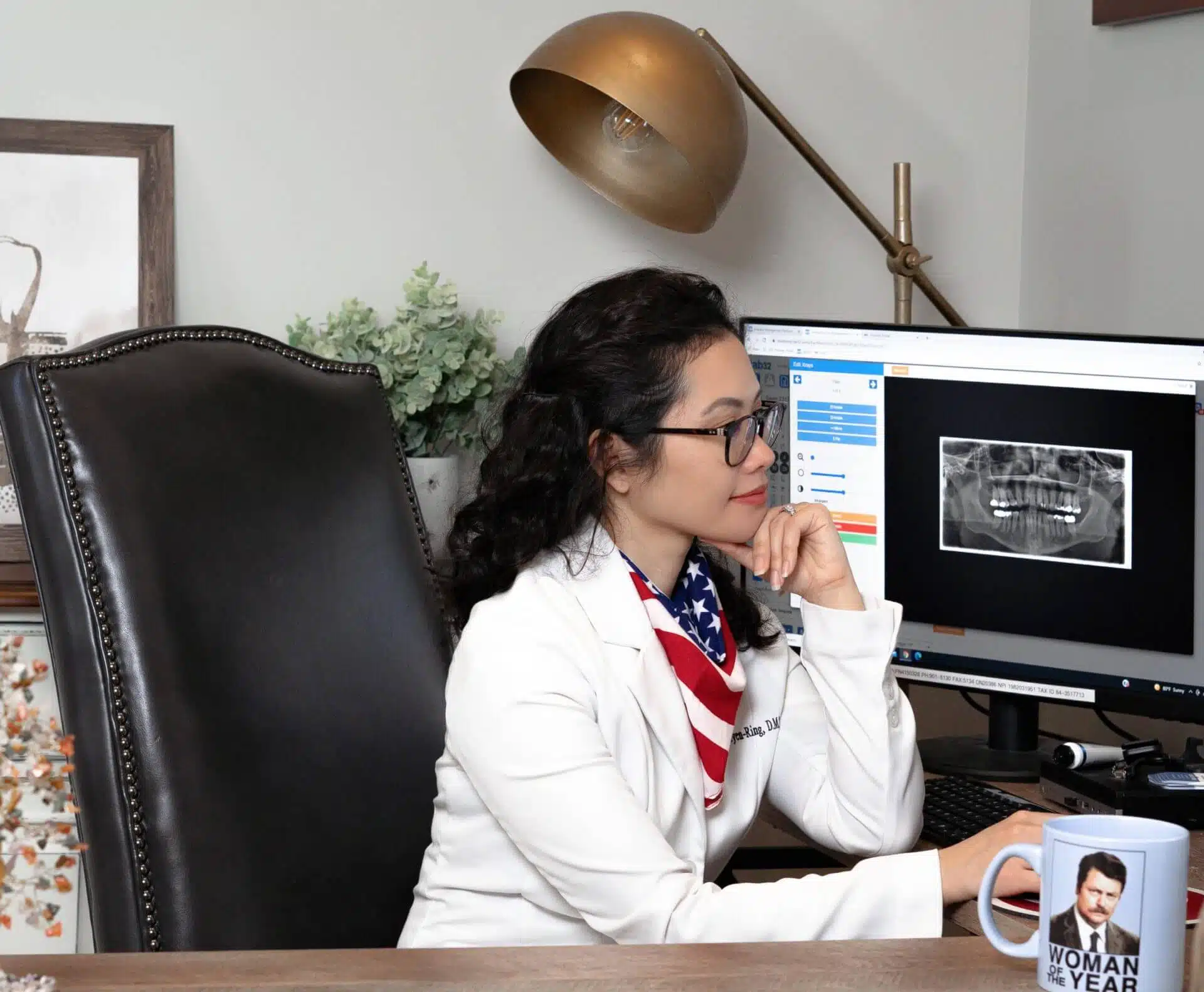 Dentist examining dental x-rays on a monitor at Southern Style Dental office, providing expert dental care.