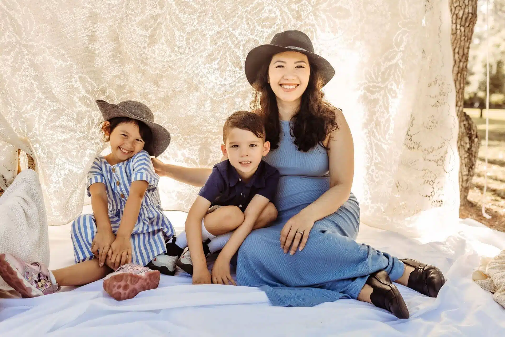 Happy family smiling outdoors under a lace canopy. Southern Style Dental promotes family dental care services.