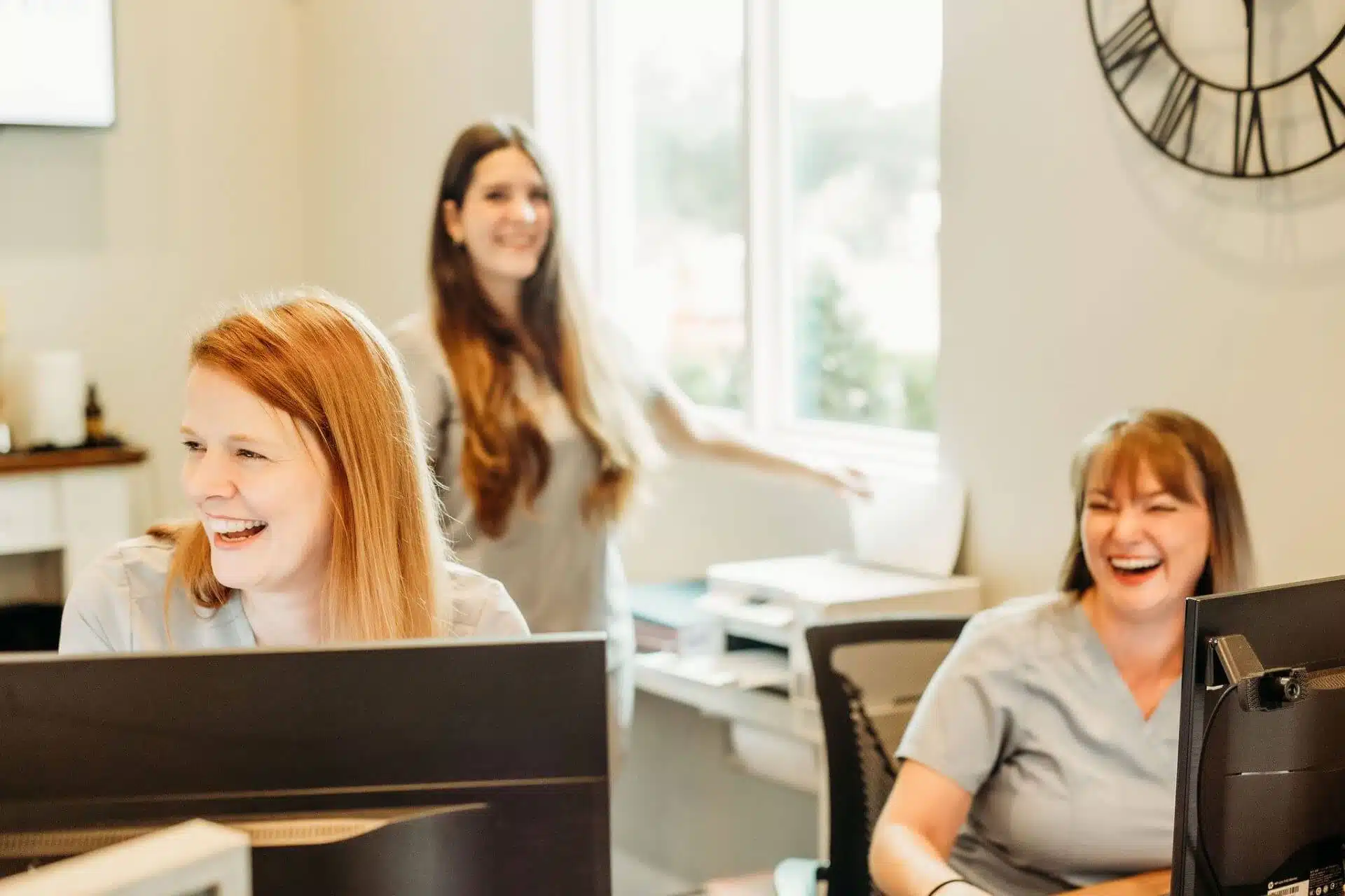 Friendly Southern Style Dental staff smiling at the reception desk, ready to assist patients in a warm, welcoming environment.