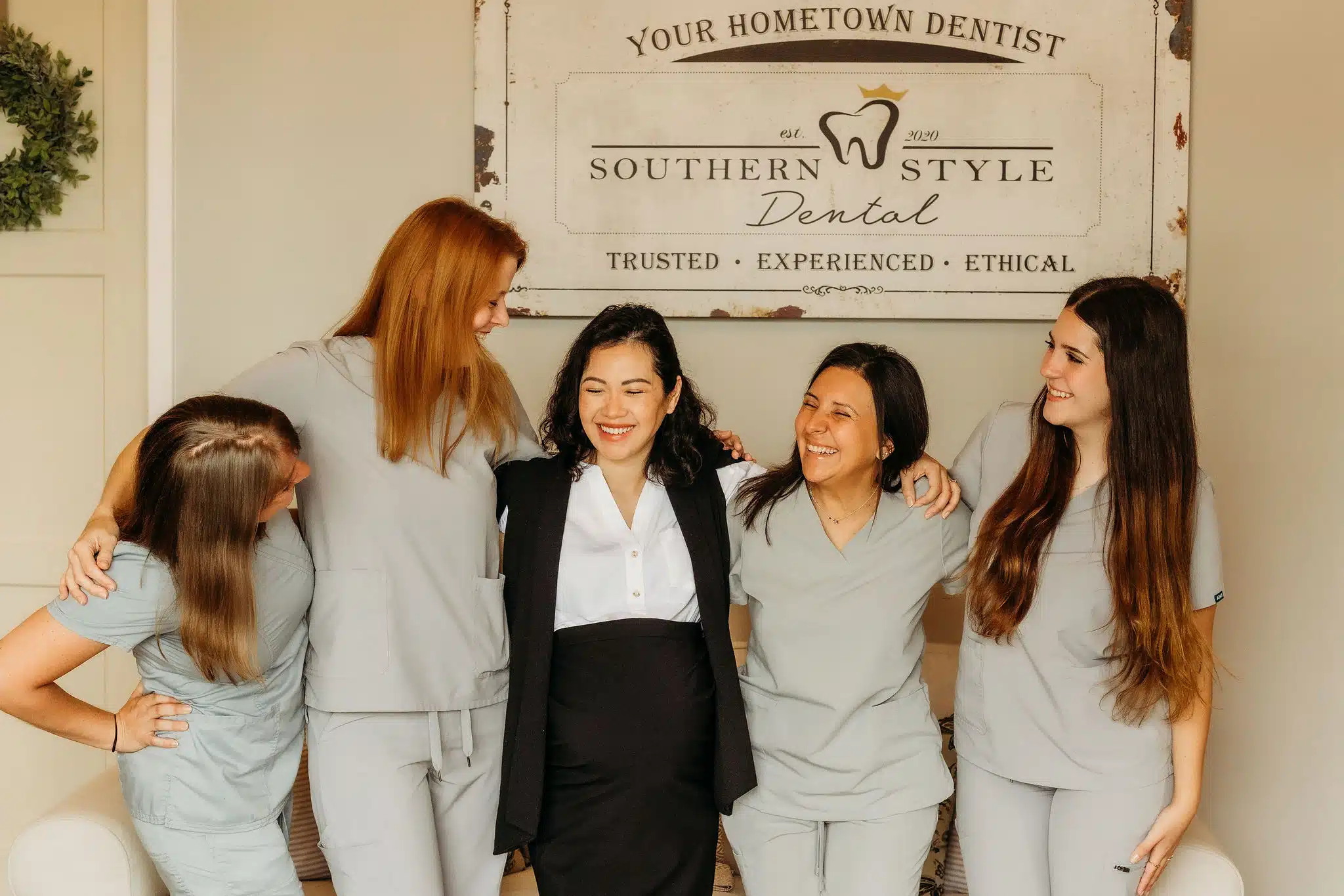 Southern Style Dental team smiling and embracing, showcasing trusted, experienced, and ethical dental care.