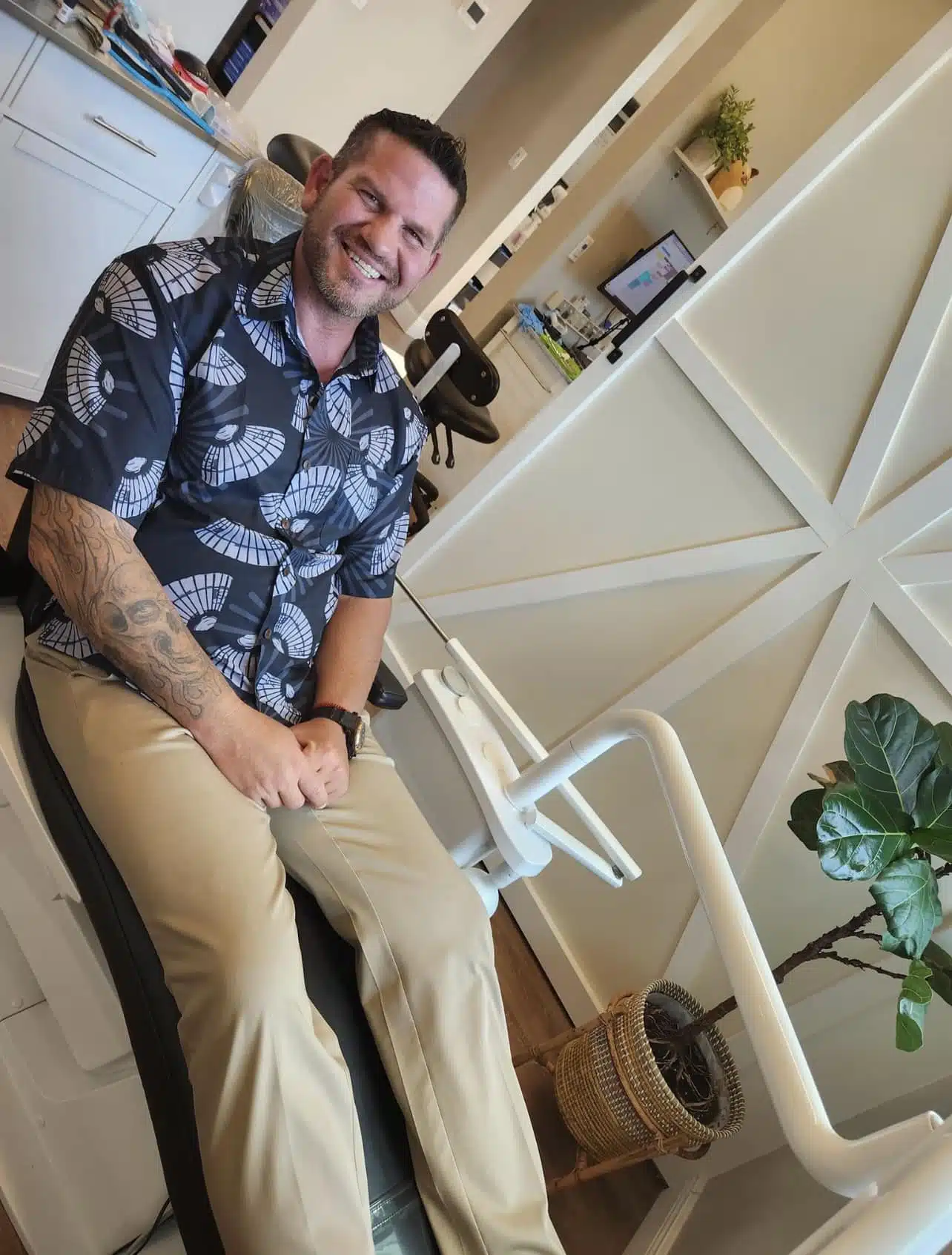 A happy patient at Southern Style Dental, sitting in a dental chair, showing a bright smile and relaxed demeanor.
